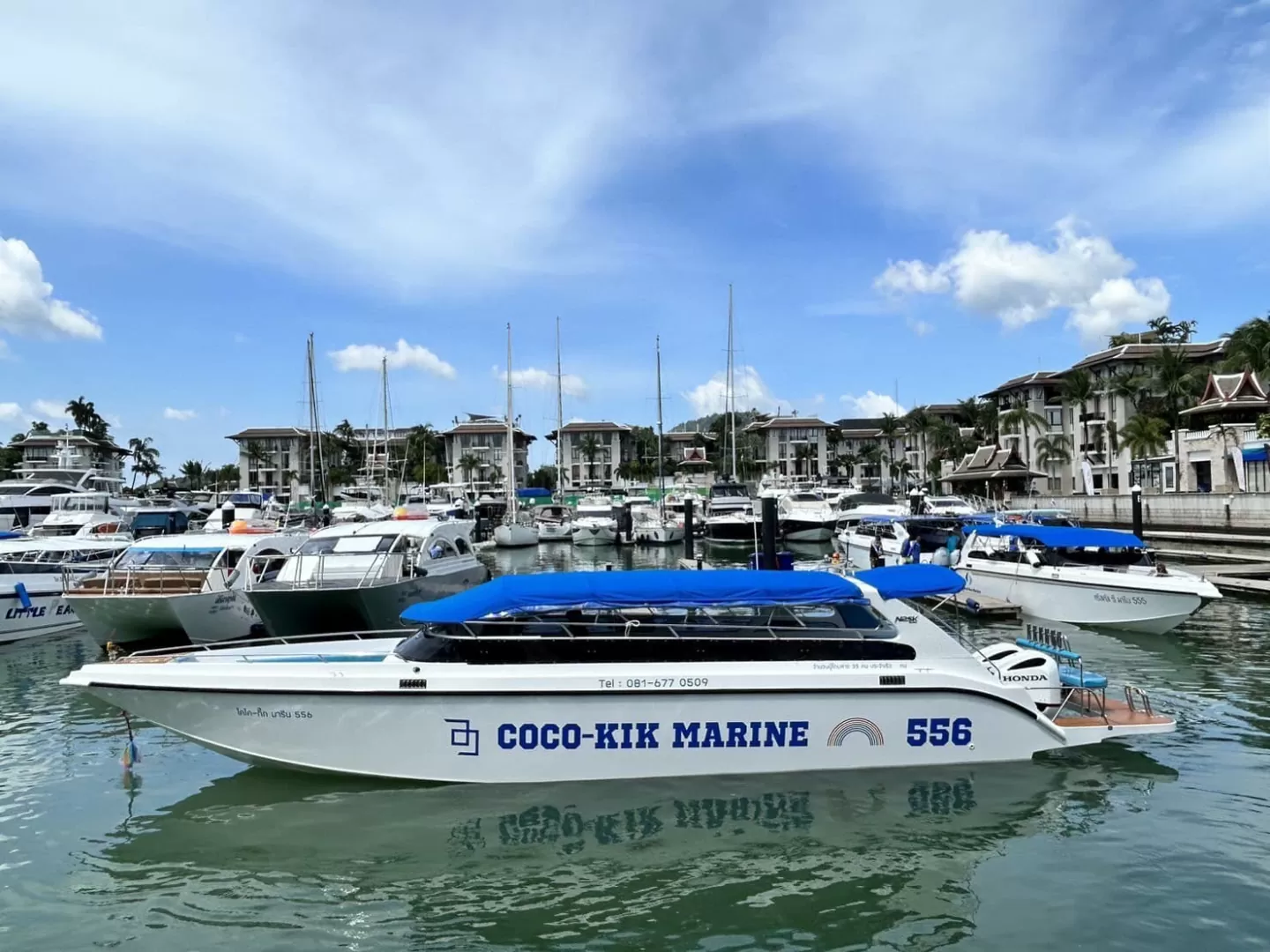 COCO-KIK MARINE 556 speedboat docked at a Phuket marina.