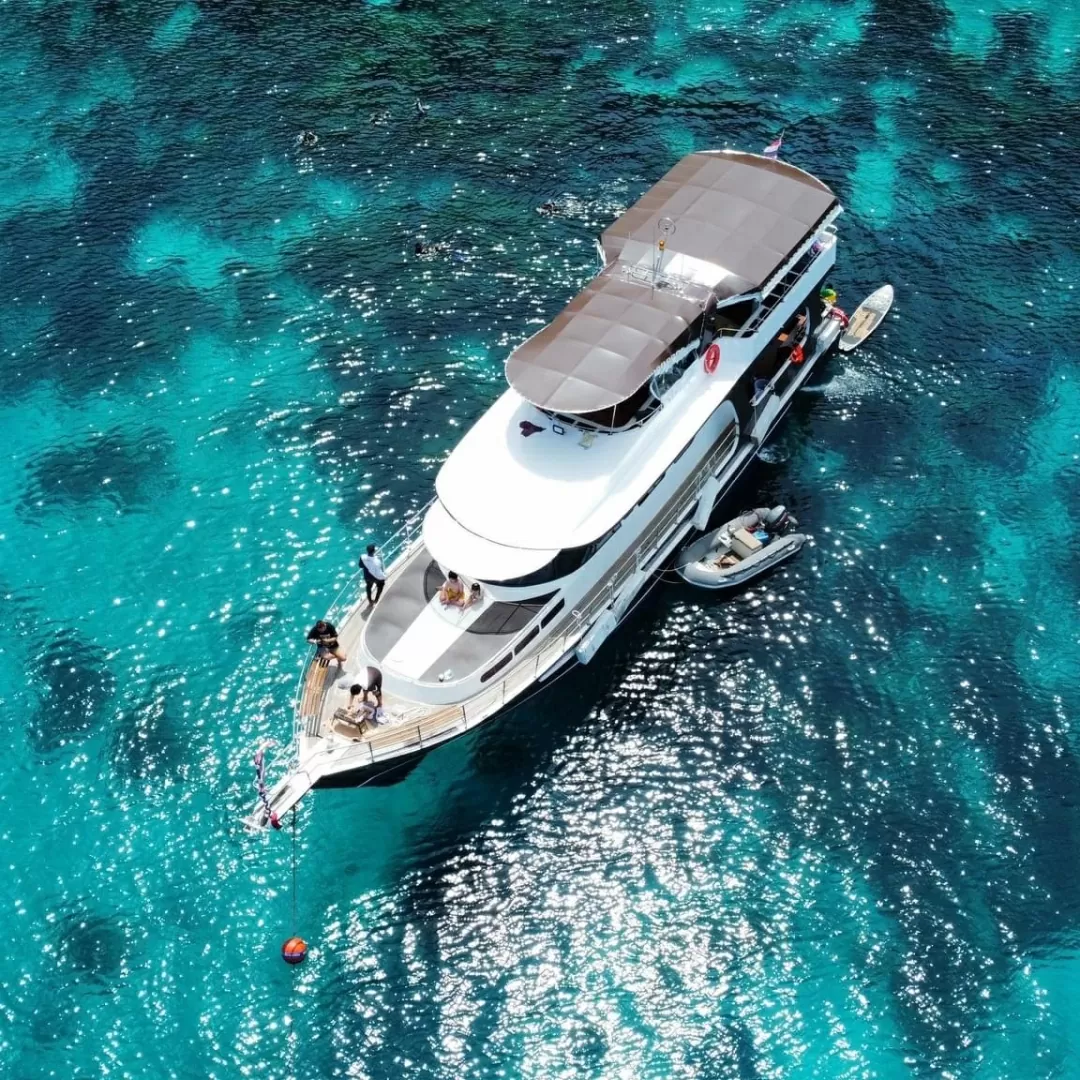 Private charter cruiser anchored in the clear blue waters of Phuket.