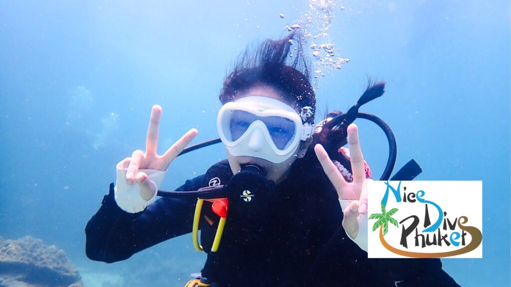 Fun scuba divers posing underwater during a guided dive session in Phuket.