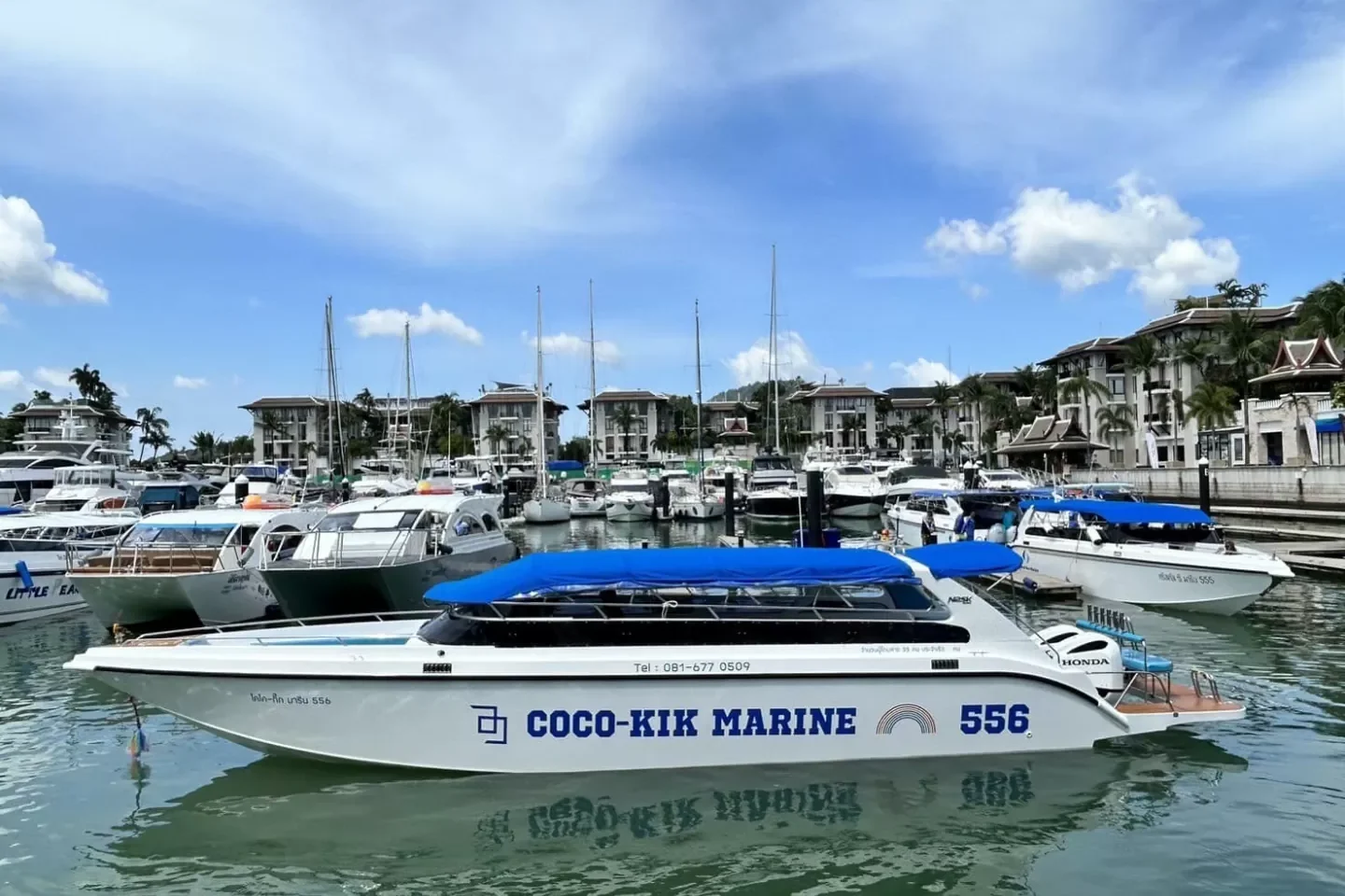 COCO-KIK MARINE 556 speedboat docked at a Phuket marina.